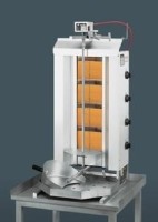 Der Dönergrill / Gyrosgrill von vorne auf einem kleinen Metalltisch stehend. Das Gerät ist eingeschaltet. Der Hintergrund ist Der Dönergrill / Gyrosgrill von vorne auf einem kleinen Metalltisch stehend. Das Gerät ist eingeschaltet. Der Hintergrund ist dunkelgrau.